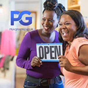 two business women smiling holding up a sign saying open